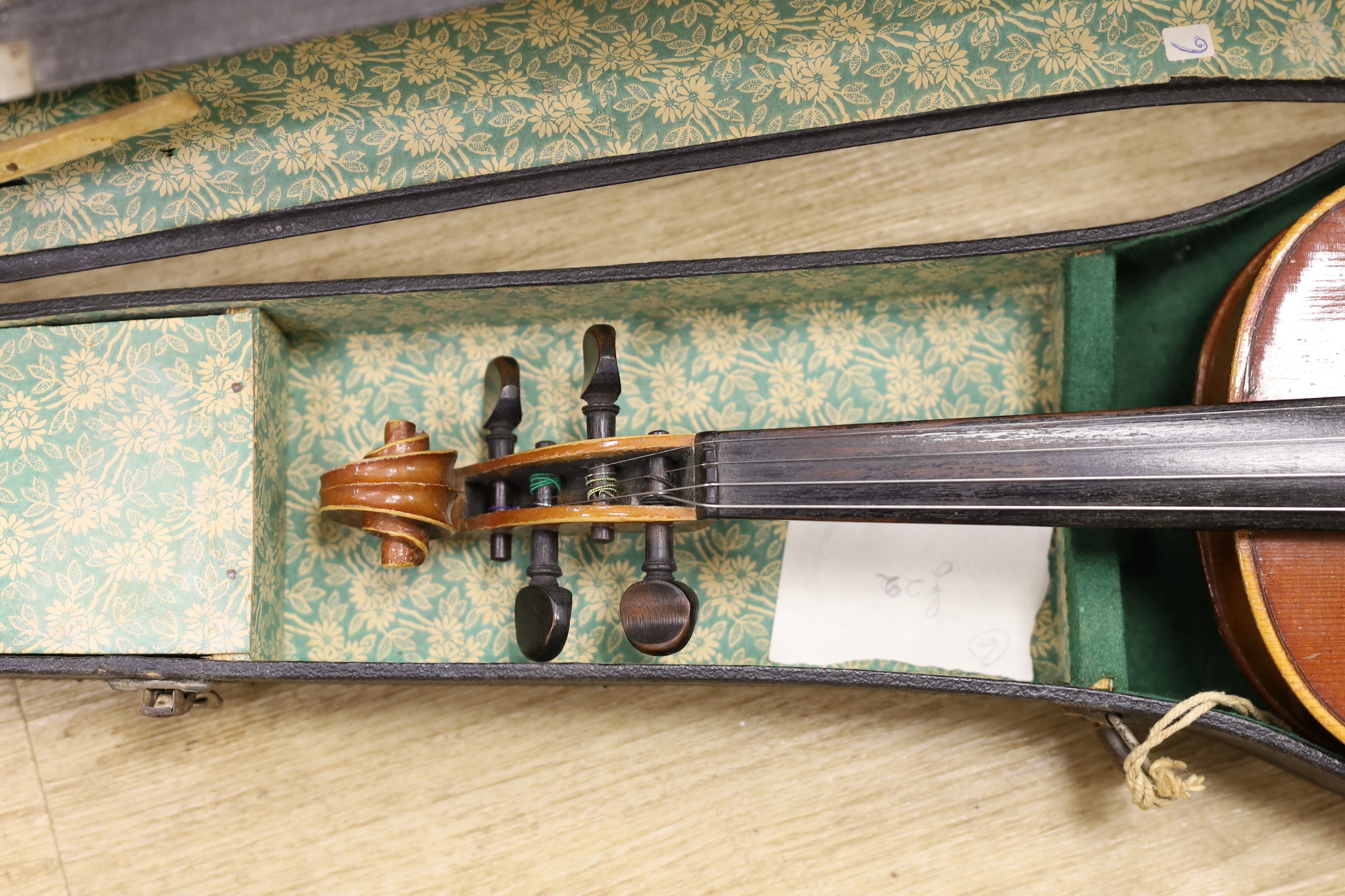 Two cased violins, one bow